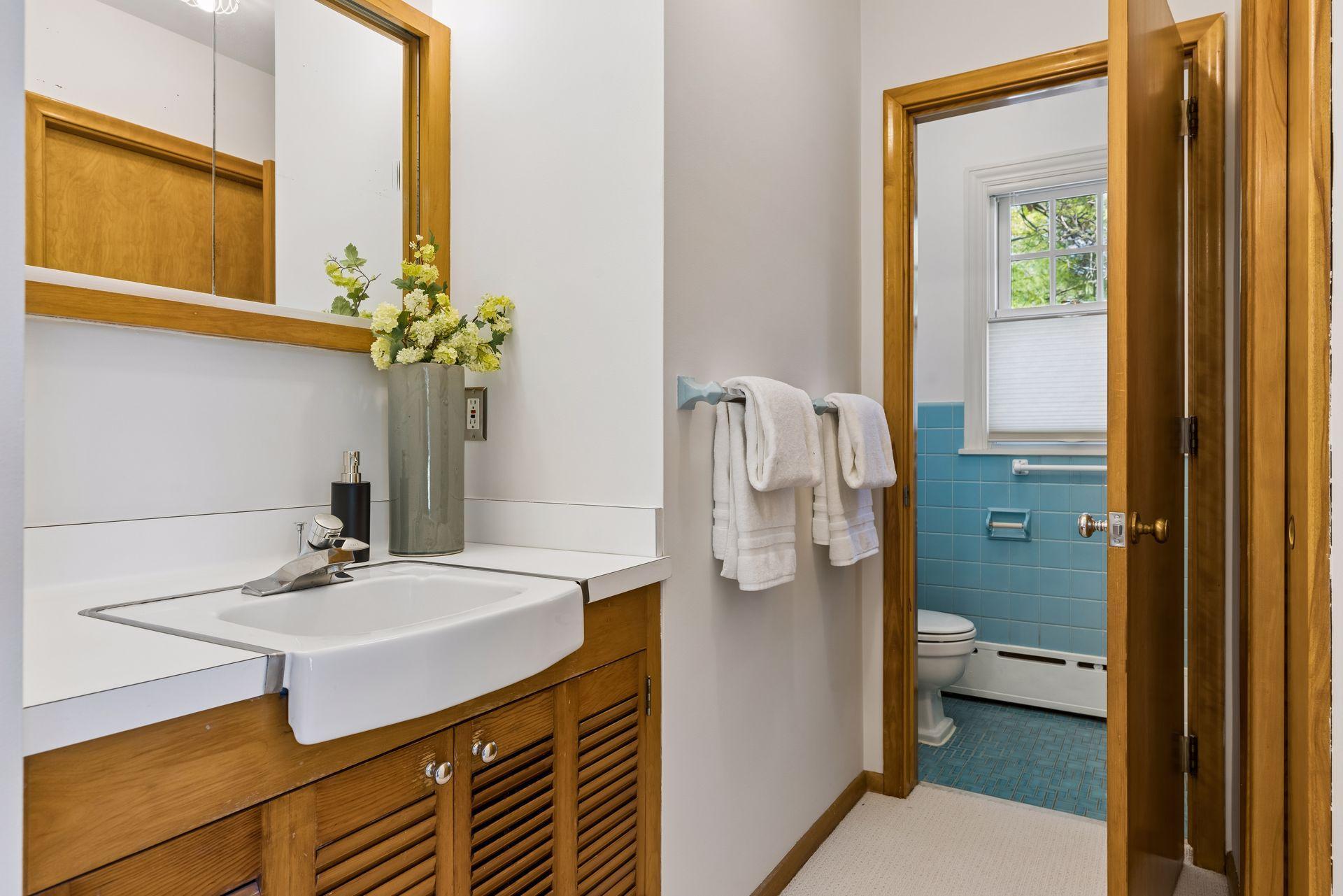The owners en suite bath and dressing area. Enjoy built-in storage, warm woodwork and fun vintage tile with updated fixtures.