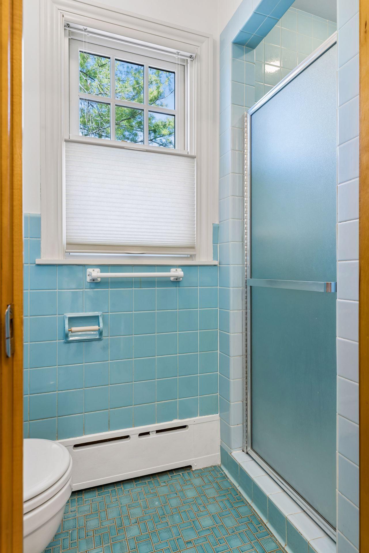 The owners suite stool and shower room has beautiful vintage tile for a pop of color!
