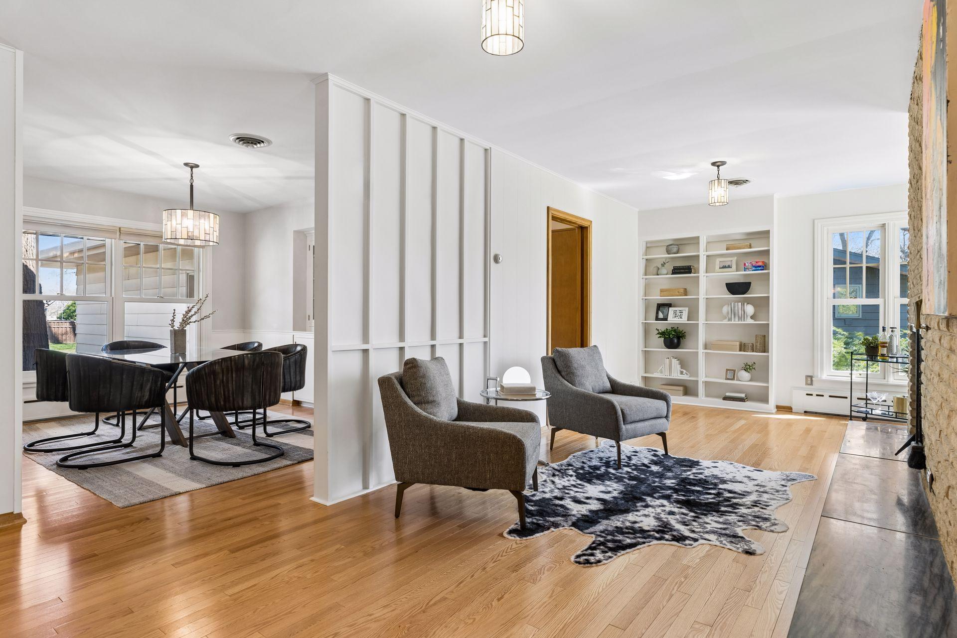 The main floor library area is the perfect place to relax next to the fireplace with a good book. It features built-in bookshelves, oversized corner windows and rich hardwood floors.
