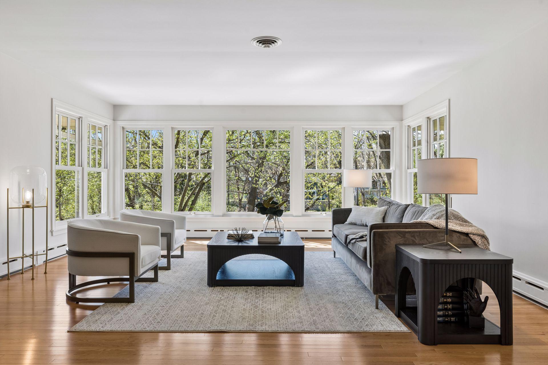 The main floor living area is spacious and bright with gorgeous hardwood floors and a wall of windows overlooking the natural beauty of the Bassett Creek valley.