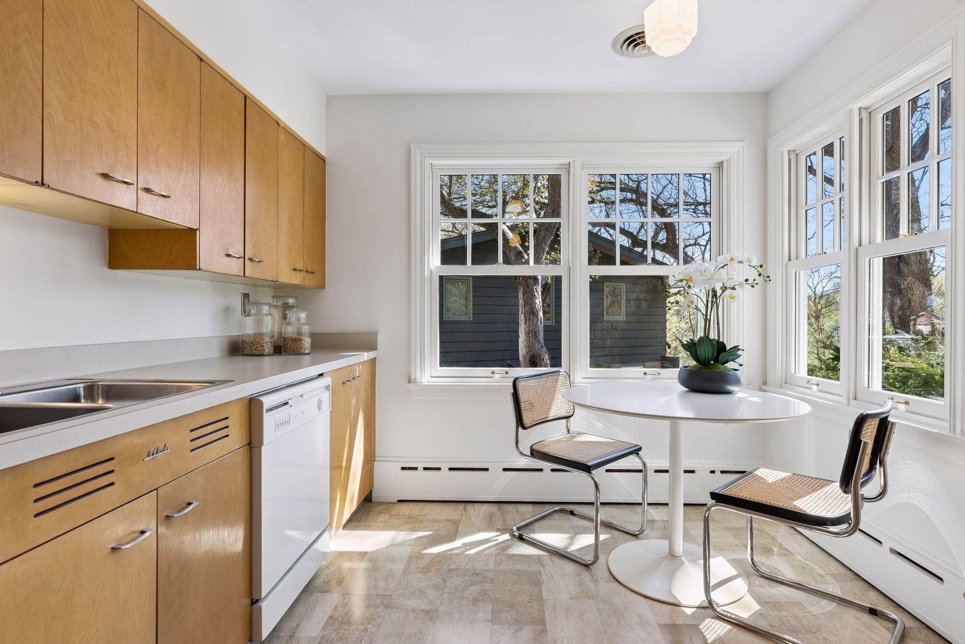 The spacious kitchen dinette area is scenic and sun-drenched with beautiful views of the yard and creek valley and solid surface flooring for easy clean up.