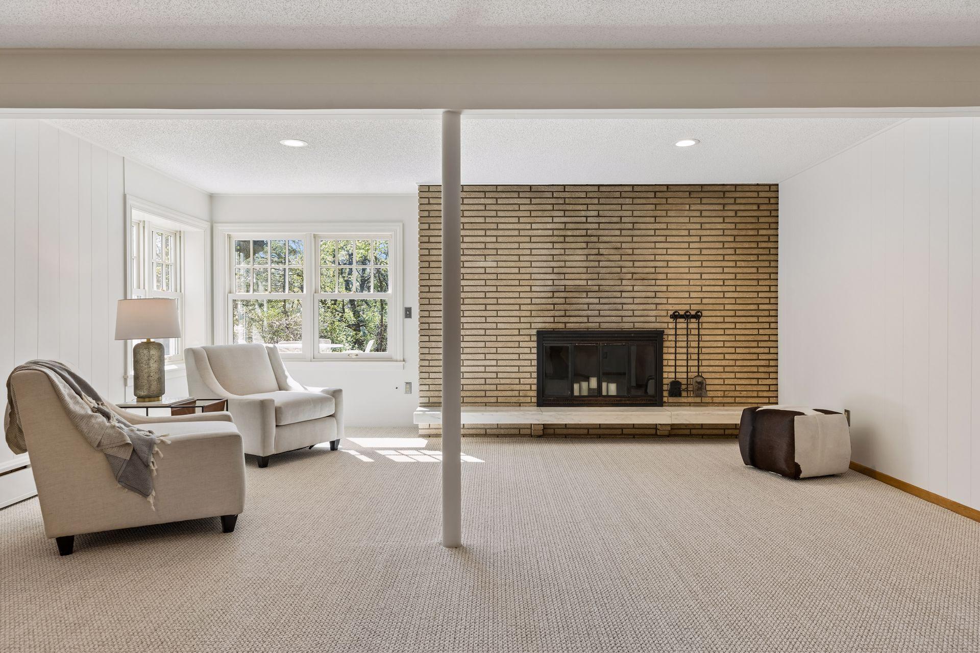 The lower level family room has a third brick fireplace (not currently suitable for wood burning), large corner windows, newer neutral carpeting and good ceiling height.