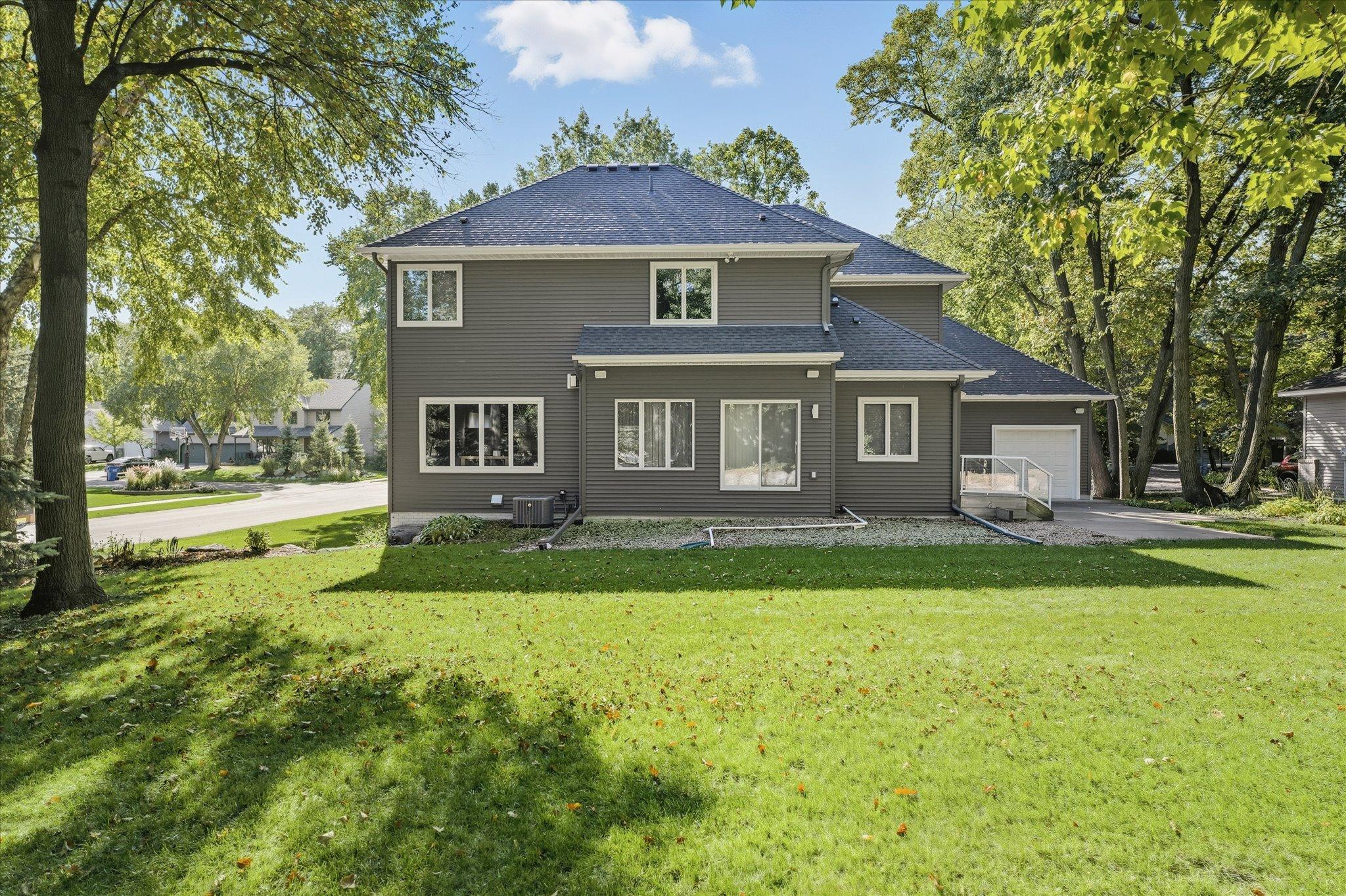 Professional landscaping including excavating, new backyard boulders and creating larger level backyard grass area great for kids and pets to roam