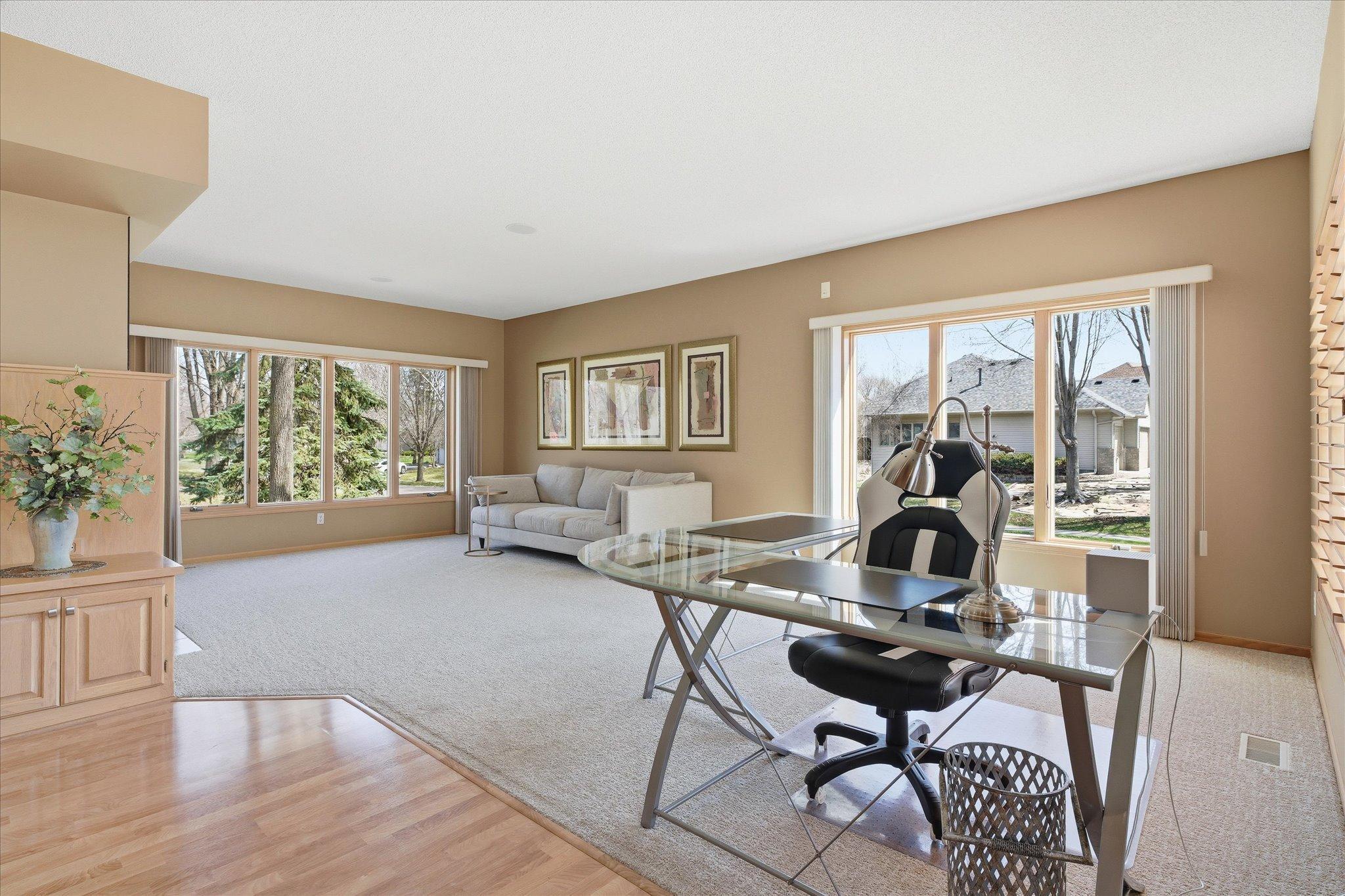 Open Family Room features: 9 foot ceilings, see-thru gas fireplace w/tile surround, `open peninsula, floor to ceiling windows, new carpeting (2025). Great open flexible space for entertaining/relaxing