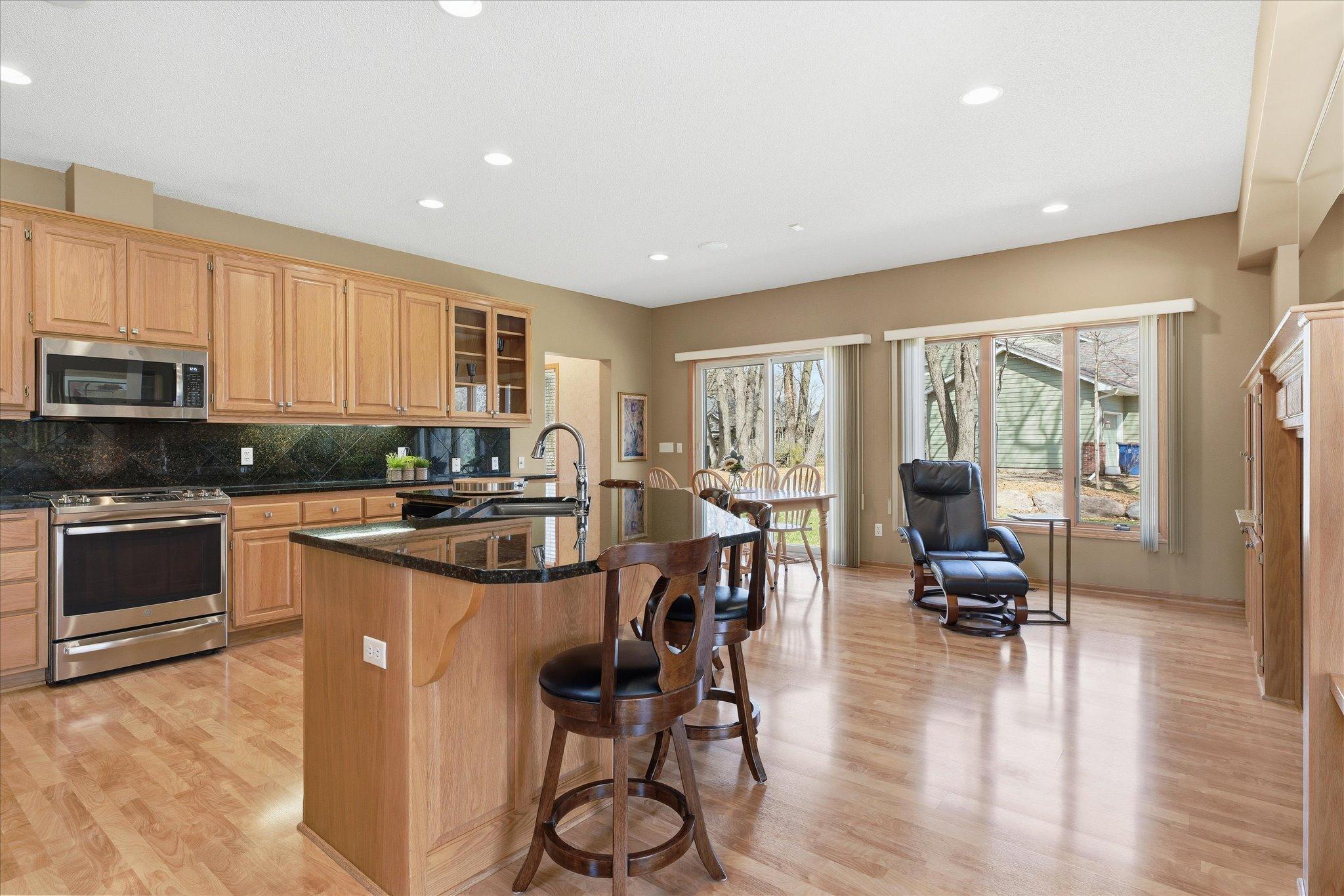 Updated Kitchen features: 9 ft ceilings, updated granite counter tops including huge flat center island, granite backsplash, ss appliances (gas range w/microwave vent to outside), recessed lights