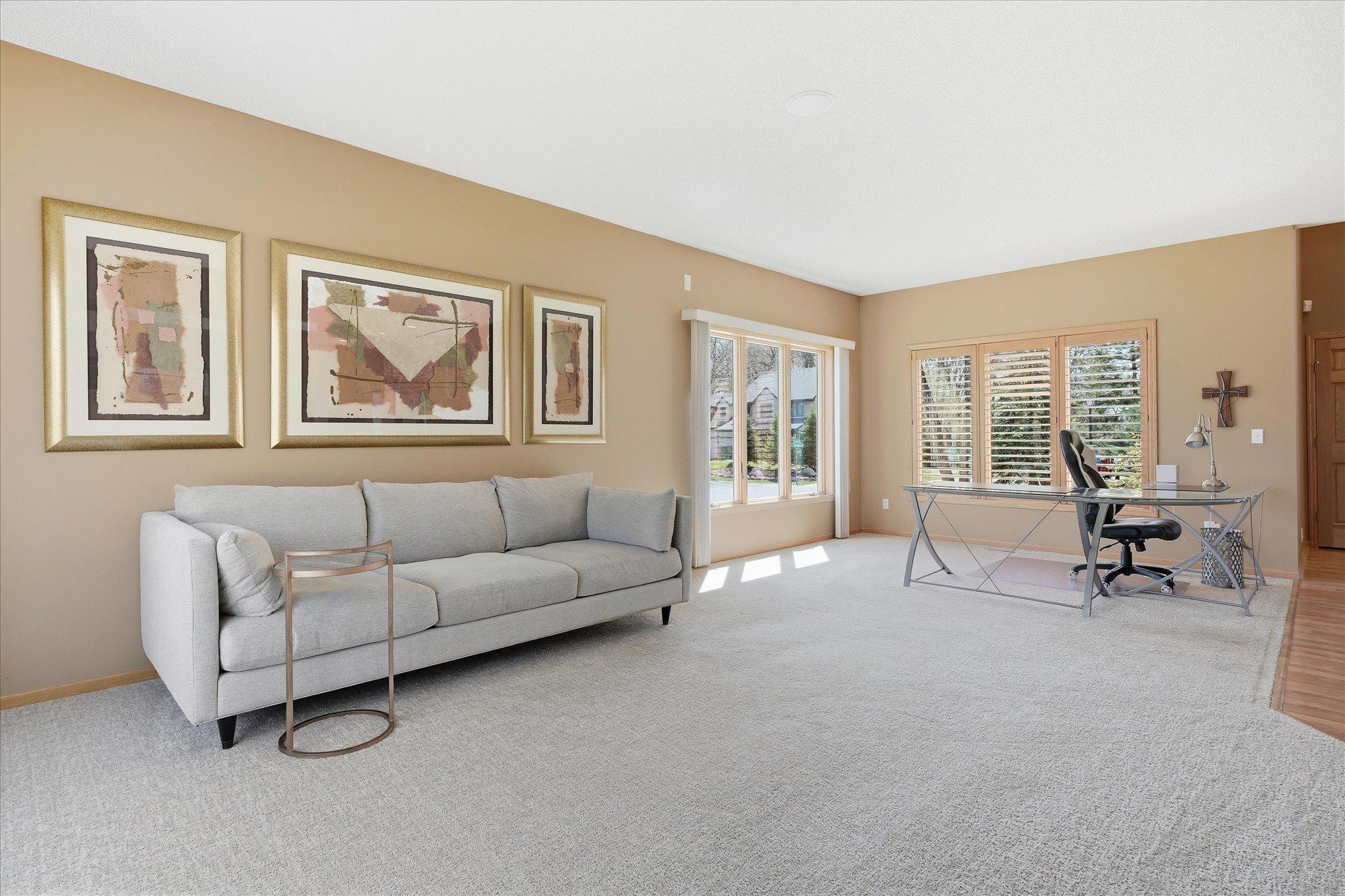 Open Family Room features 9 ft ceilings, oversized Anderson windows and new carpeting (2025). Great open flexible space for entertaining/relaxing