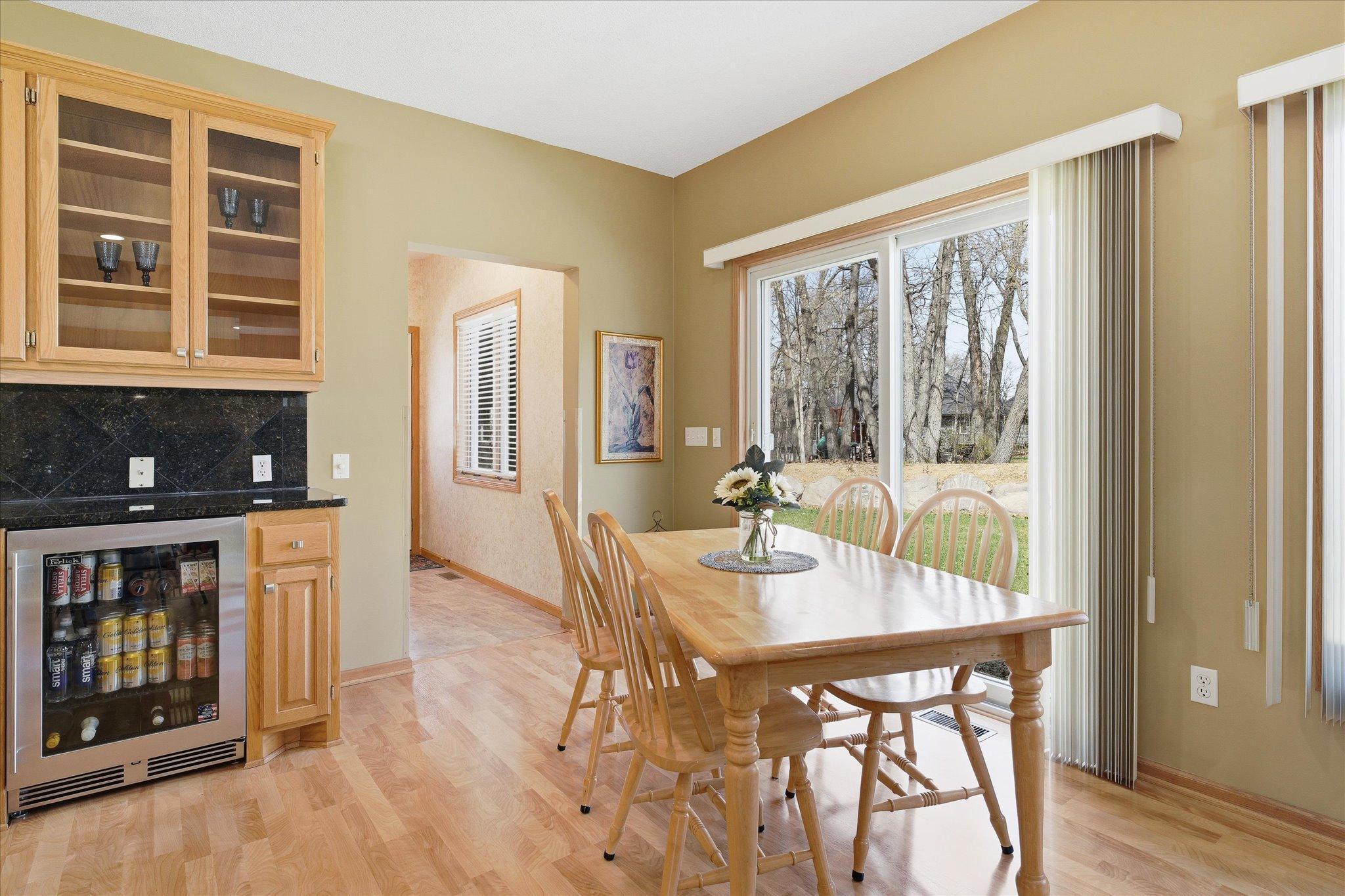 Quality "Perlick" commercial style beverage refrigerator is great for entertaining with family and friends. Open Informal Dining Room leads to Powder Room/Half bathroom and outside door to patio