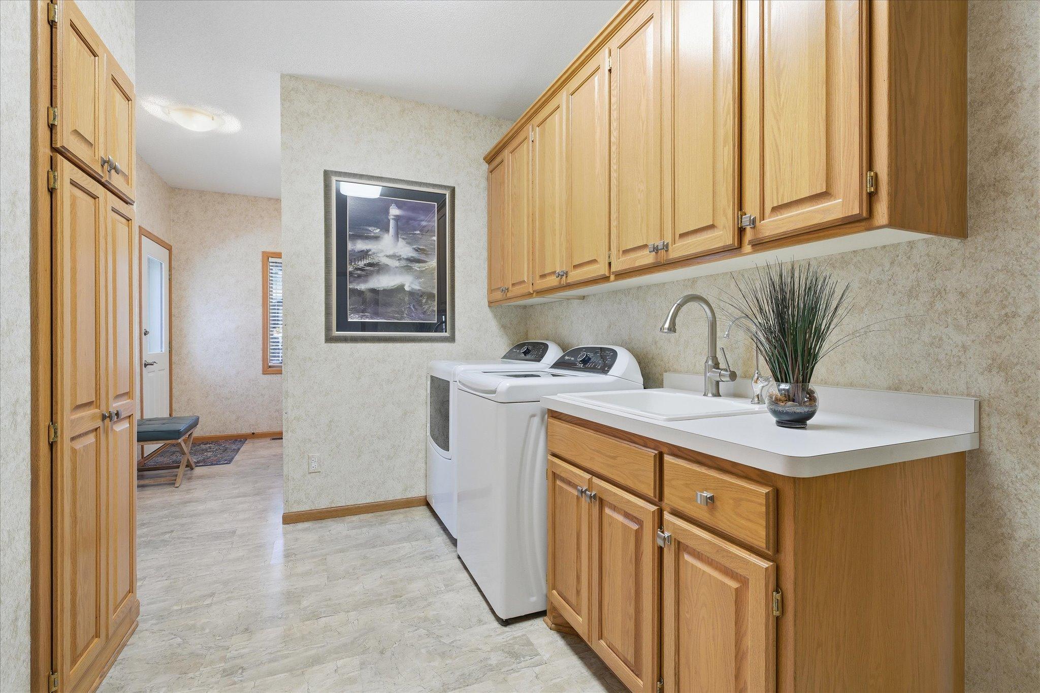 Amazing 20ft long Laundry/Mudroom/Bathrm features: door to backyard, two windows, plenty of counter/closet/cabinet storage space, updated flooring, updated faucet/sink and newer washer and dryer to stay. Private Half Bath/Powder Room