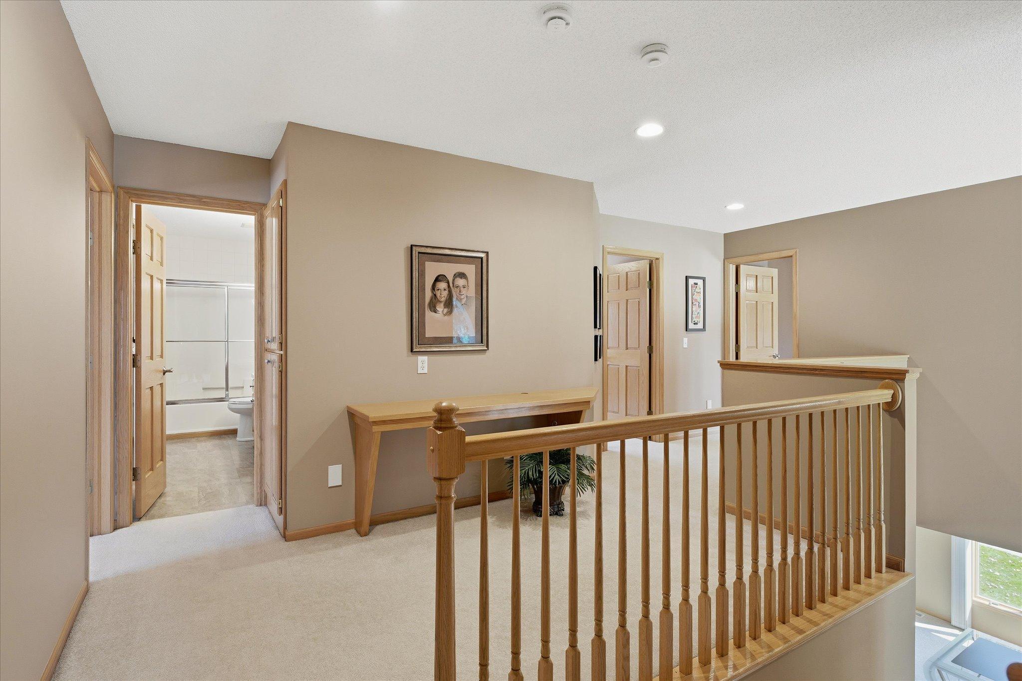 Open upper level Loft area with built-in desk is great area for kids. Open railing and recessed lights