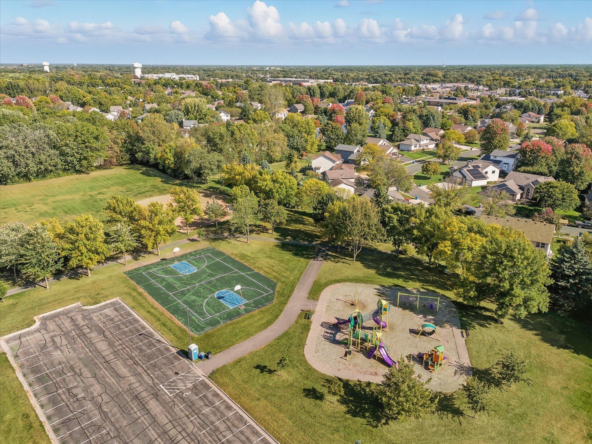 Aerial view of trails to nearby Woodlawn Park. Playground equipment, court and ball field