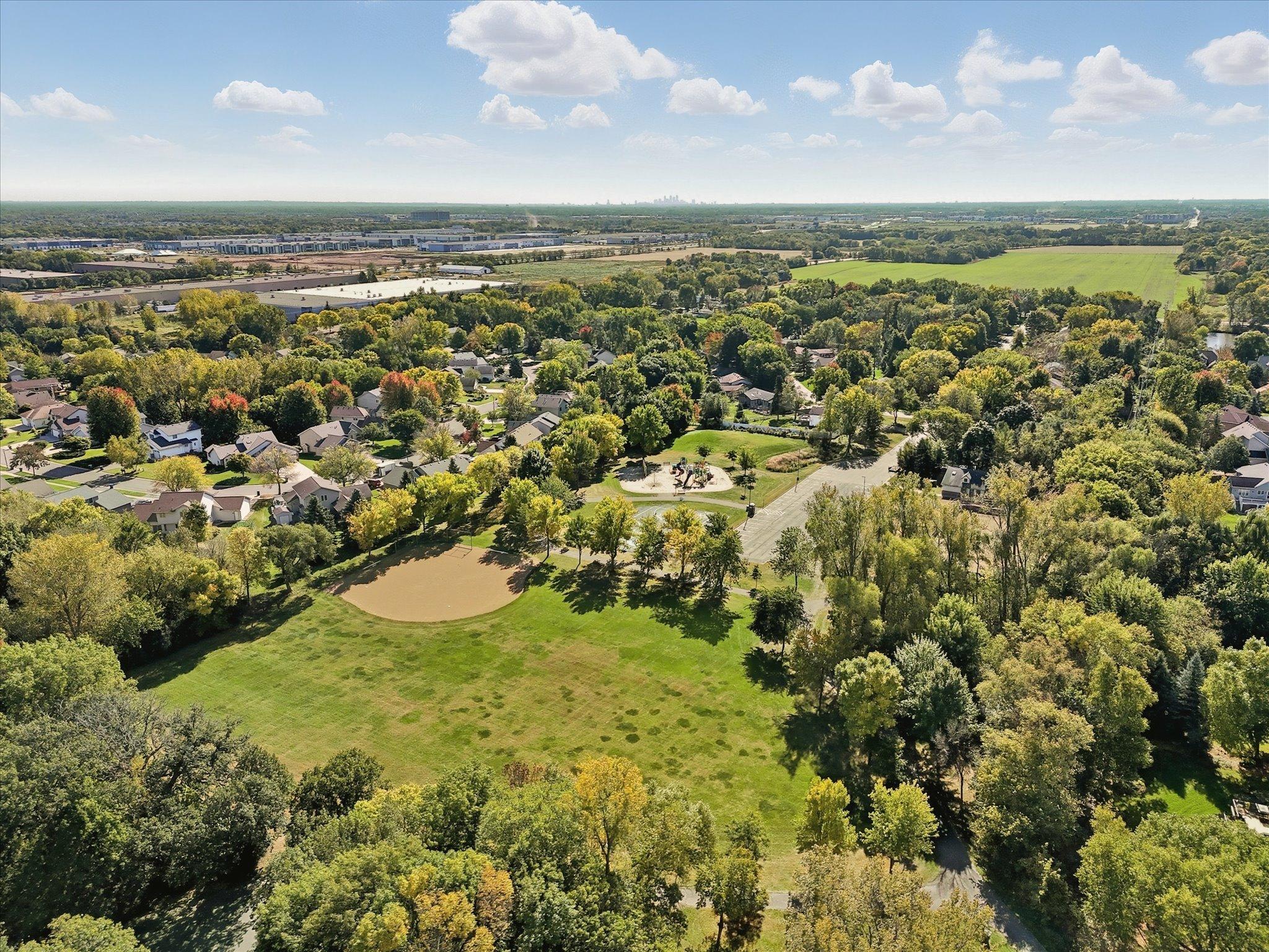 Aerial view of trails to nearby Woodlawn Park. Playground equipment, court and ball field