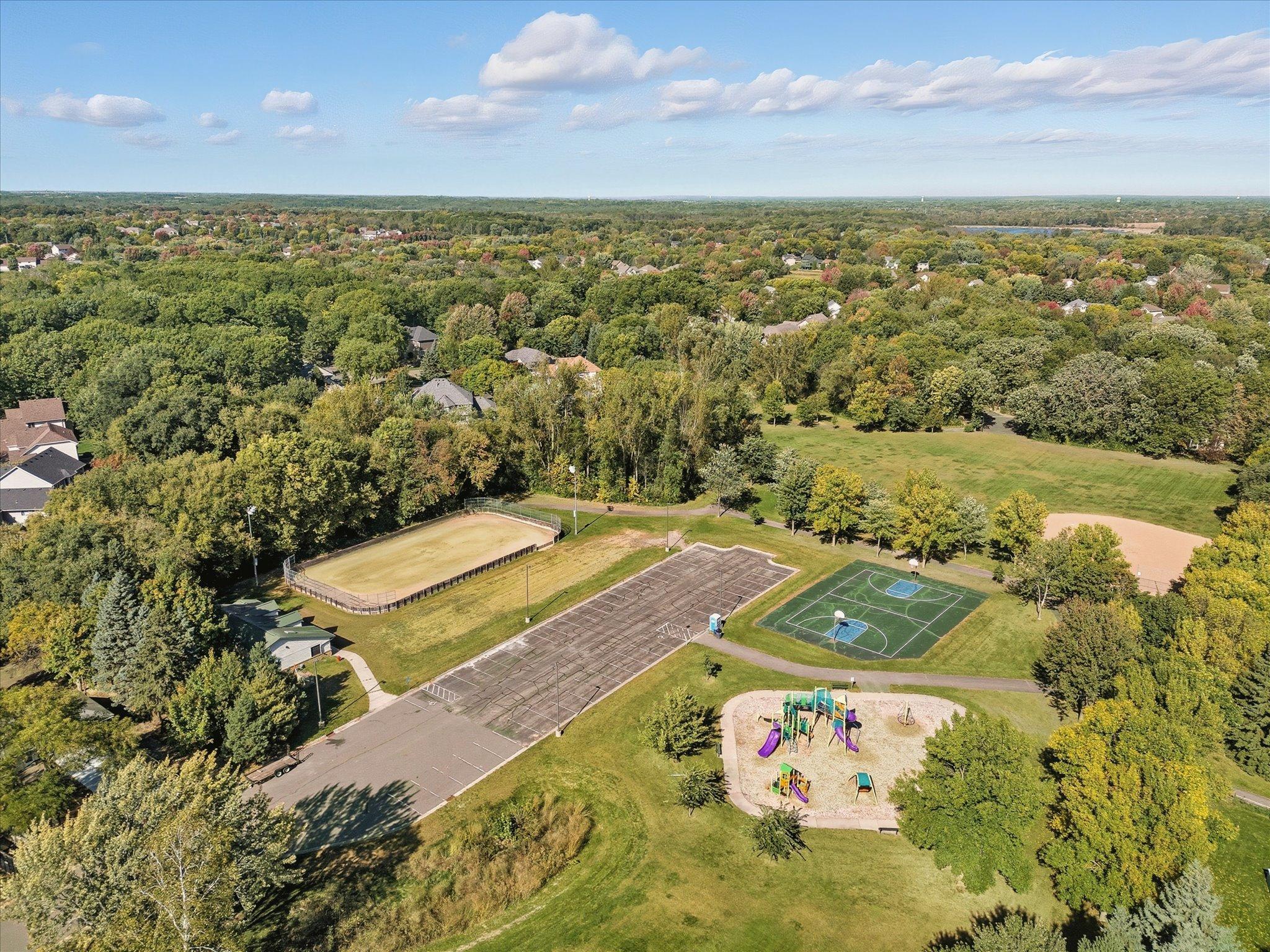 Aerial view of trails to nearby Woodlawn Park. Playground equipment, court and ball field