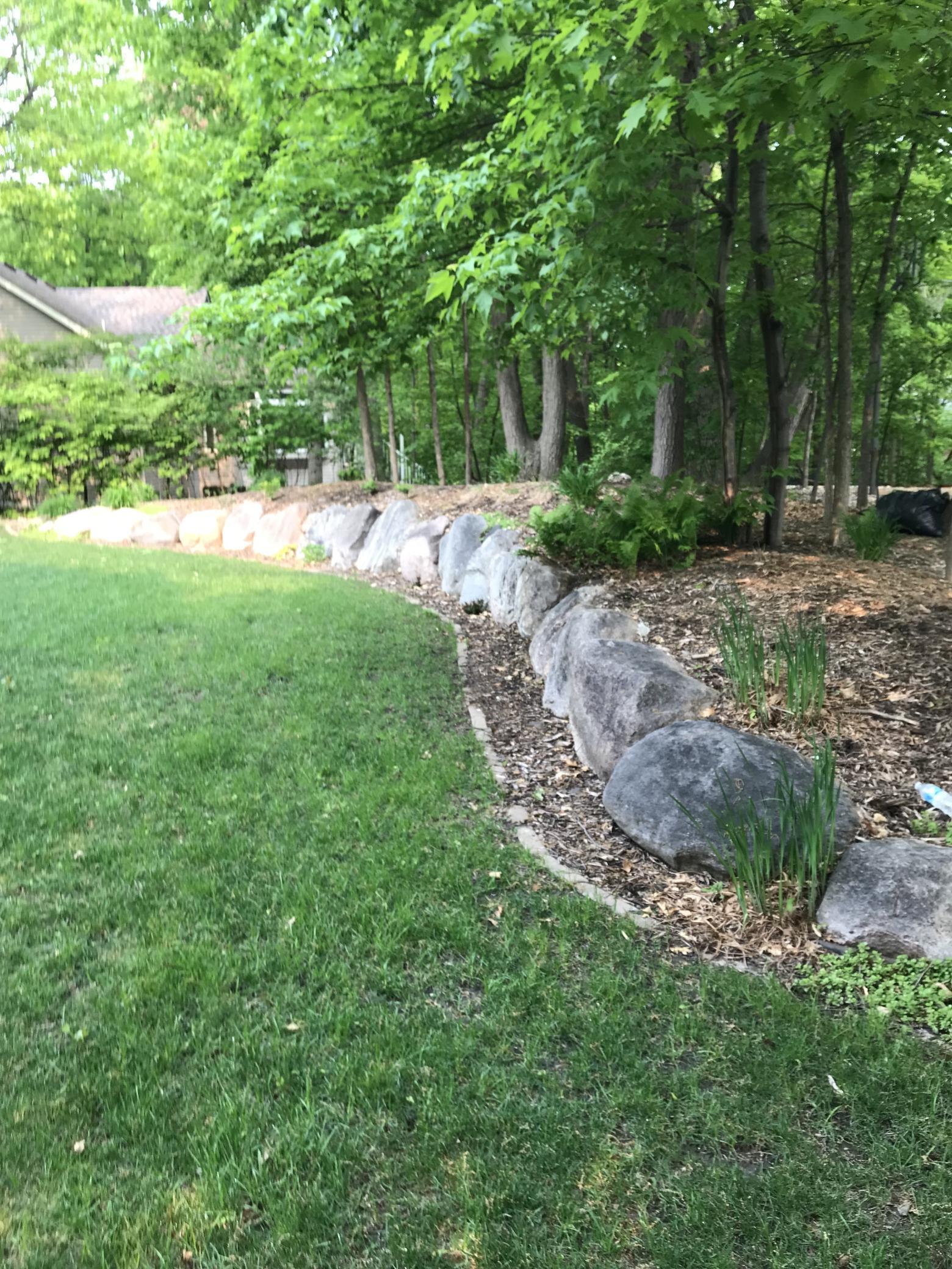 Professionally landscaped with boulders and stone edging