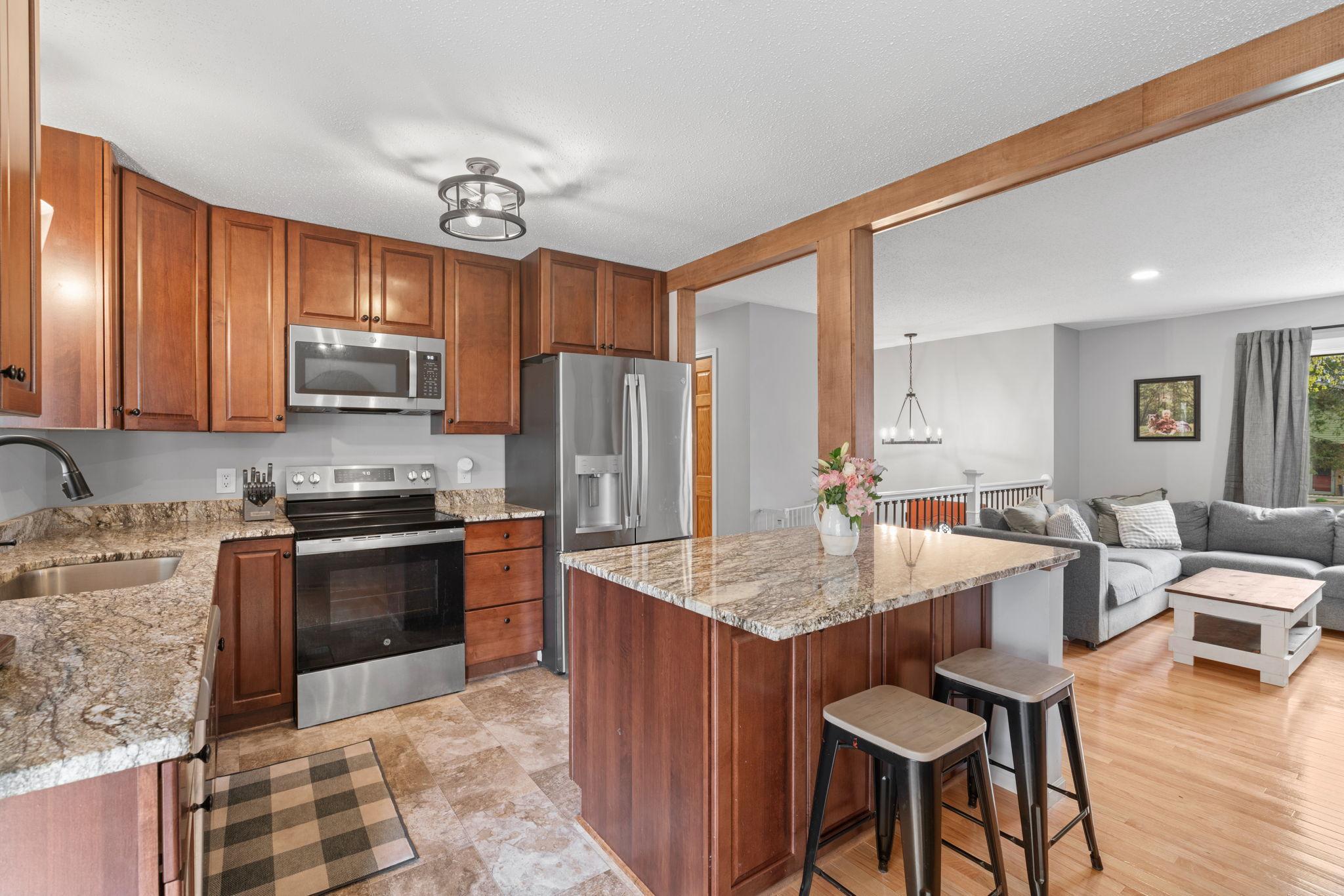 Kitchen with island seating and open connection to main living space