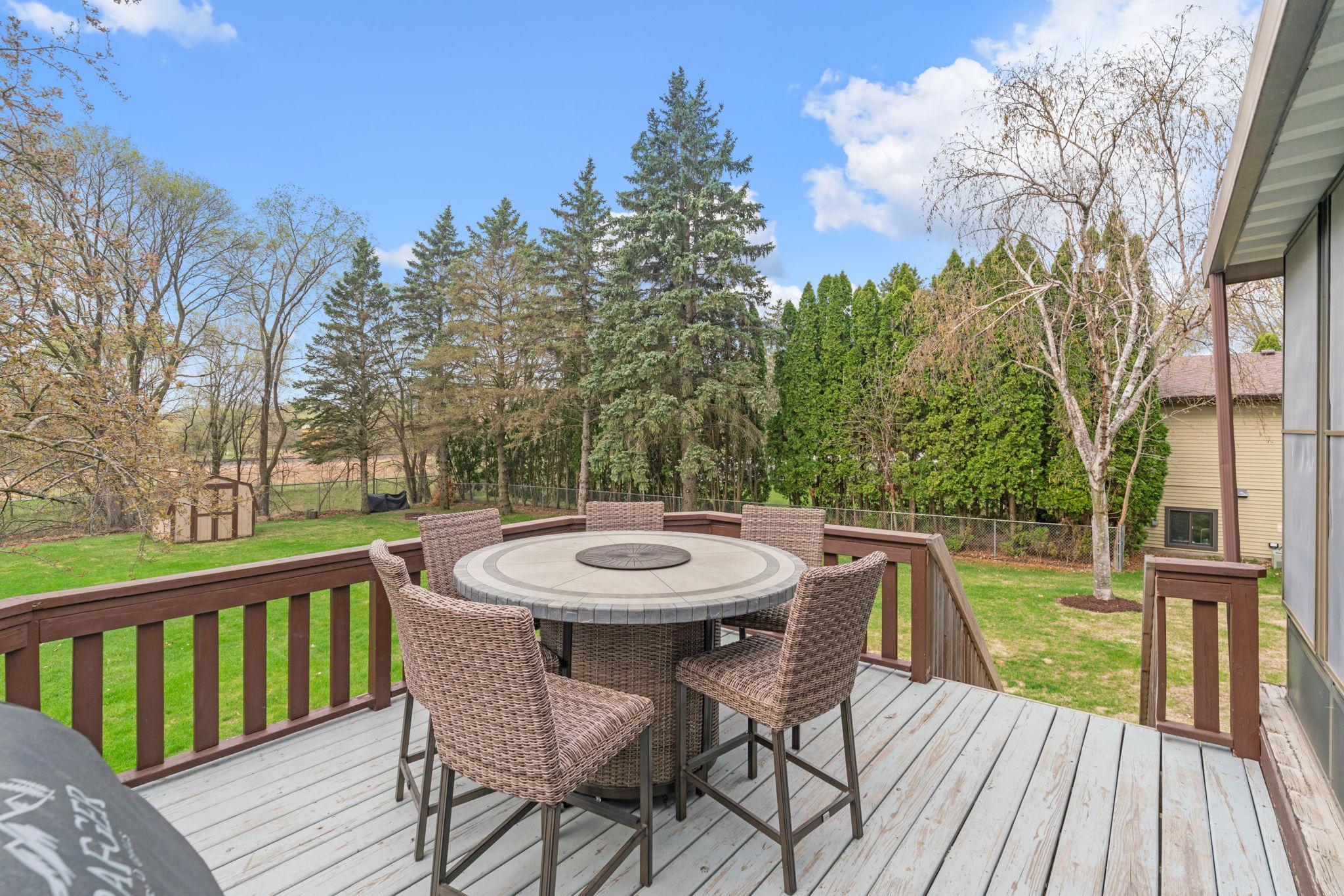 Expansive Deck overlooking large backyard with mature trees