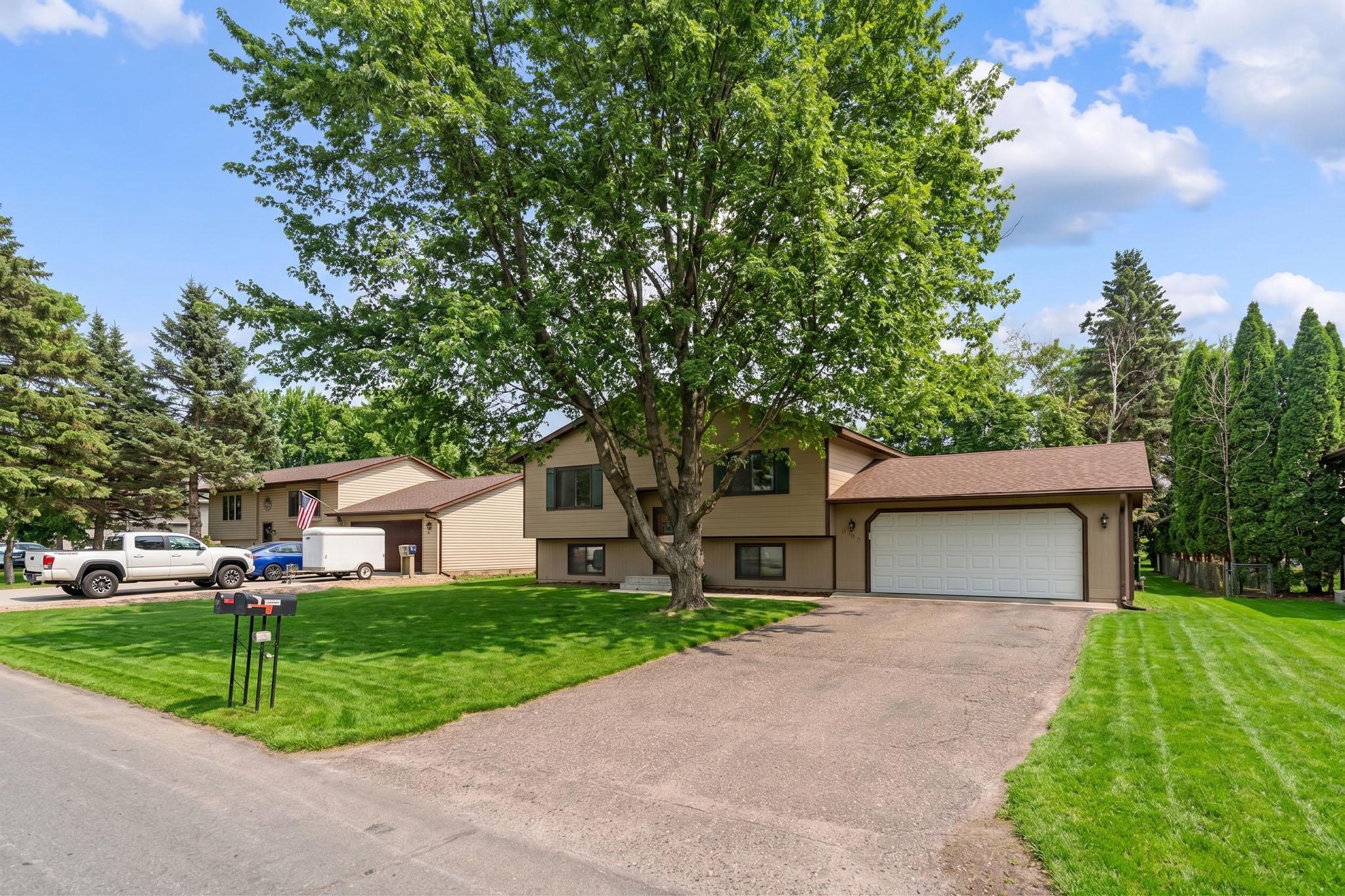 Front Exterior with Spacious Driveway and Mature Trees