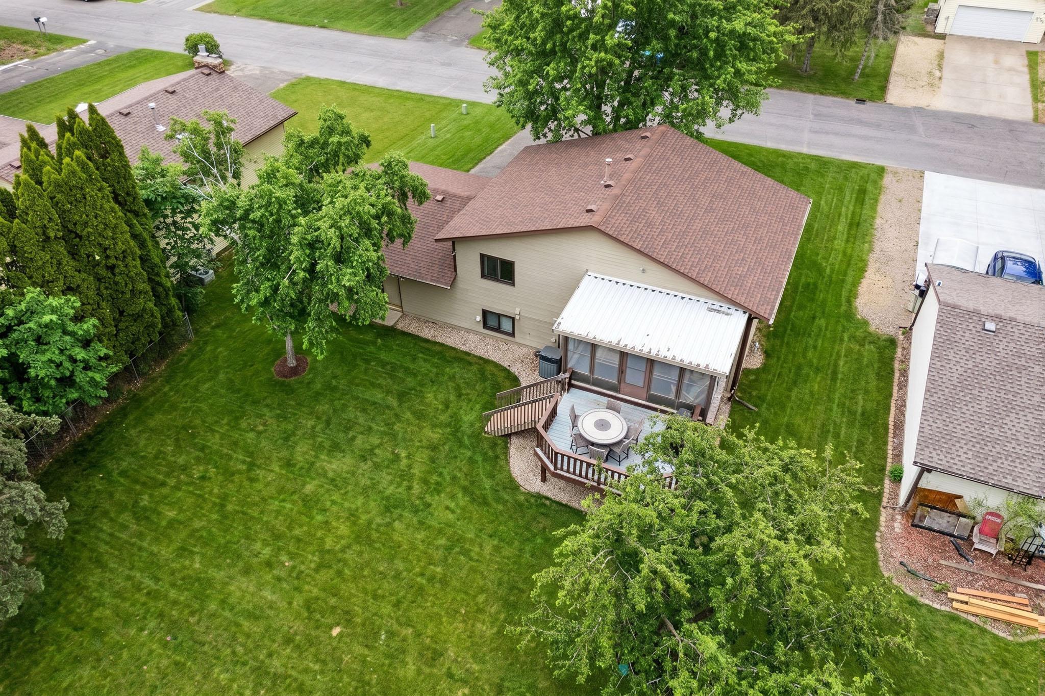 Aerial View Showcasing Yard, Deck, and Surrounding Neighborhood
