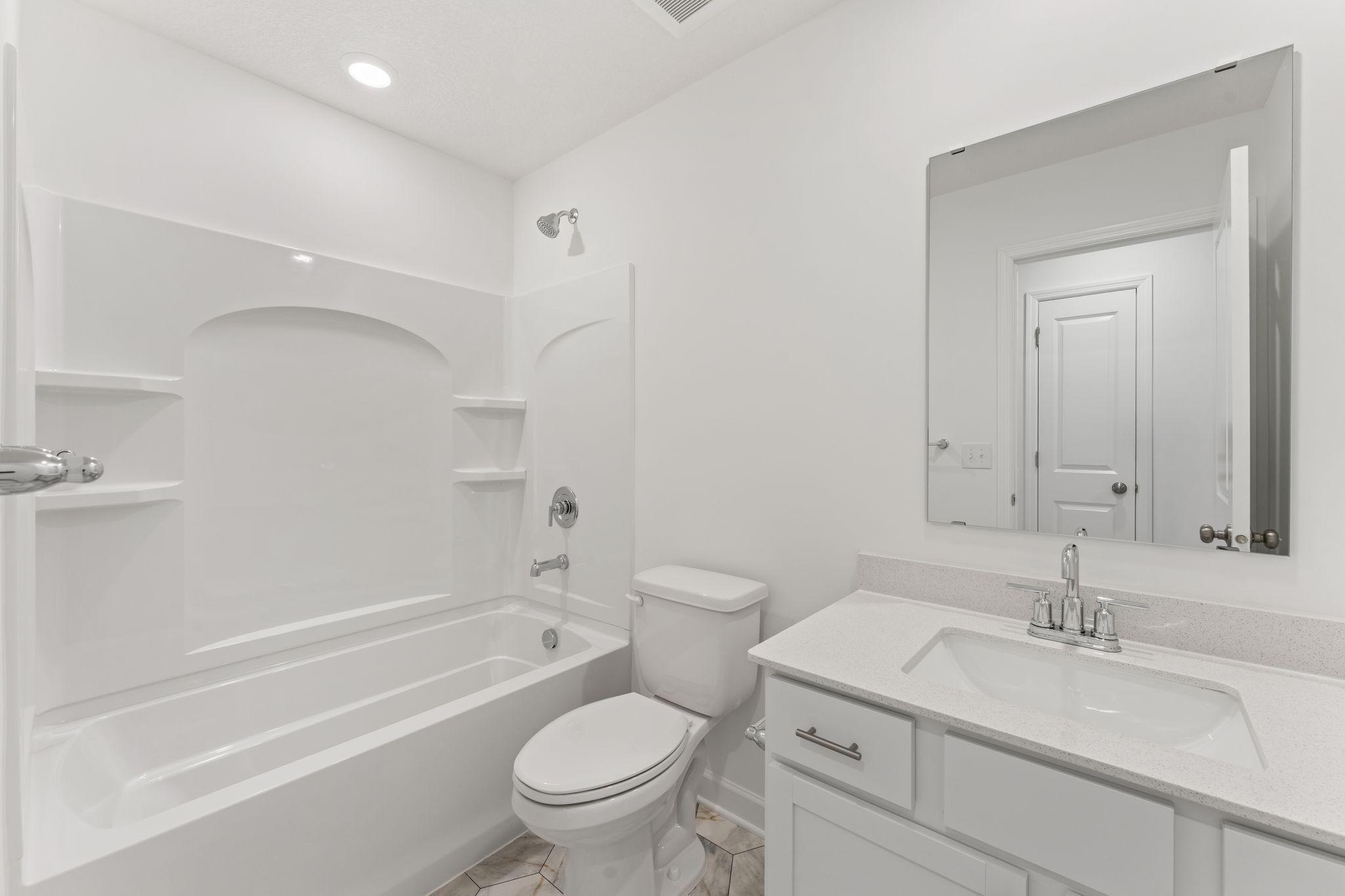 This full-sized bathroom is near the secondary bedrooms and features a single vanity and shower-tub combination.