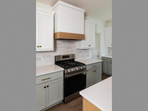 Vented exhaust with custom wood hood over stove inKitchen