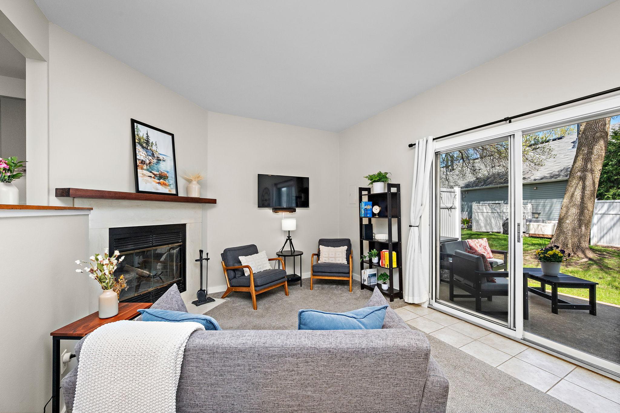 A Warm and Inviting Living Room centered around a cozy fireplace is perfect for relaxing or hosting.