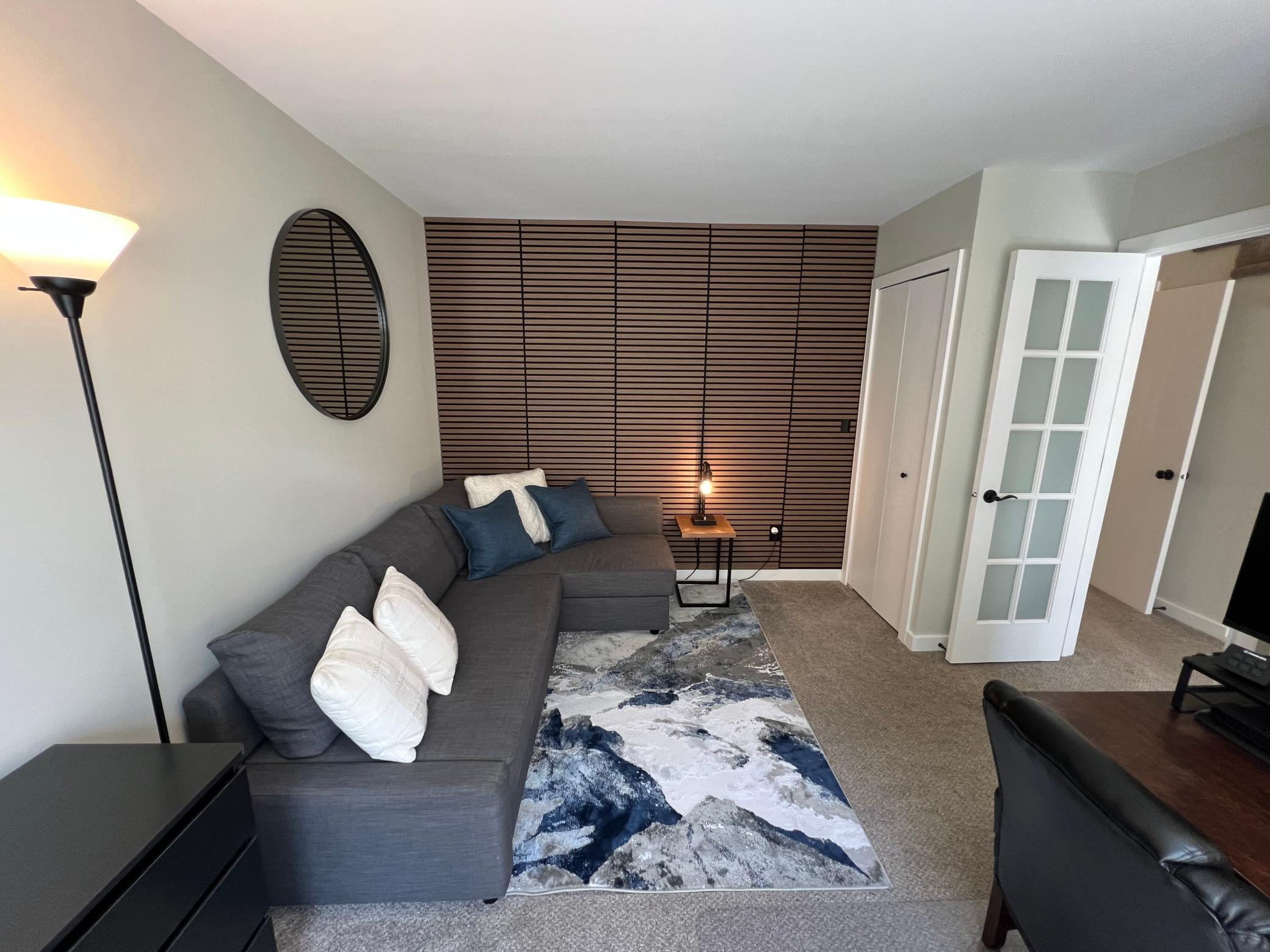 Main Level Office/Bedroom with French doors and a soundproof wall makes it ideal for working from home or hosting guests.