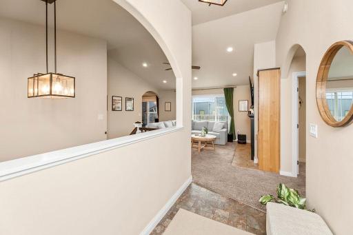 Foyer view to Living, arched opening to staircase