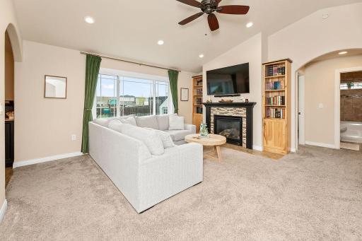 Living Room features ceiling fan, vaulted ceiling, fireplace & built-ins