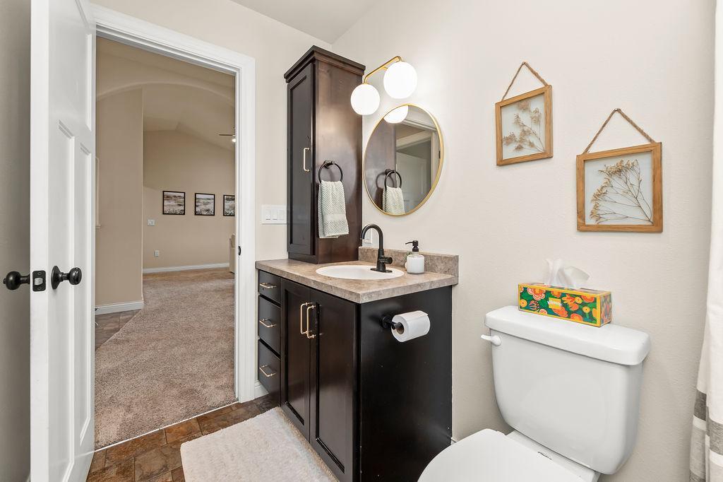 Full Bath on the main level w/ linen cabinet & tiled shower surround