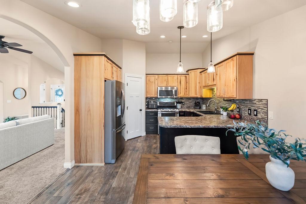 Kitchen offers recessed lighting, corner pantry, tile backsplash, two-toned cabinets
