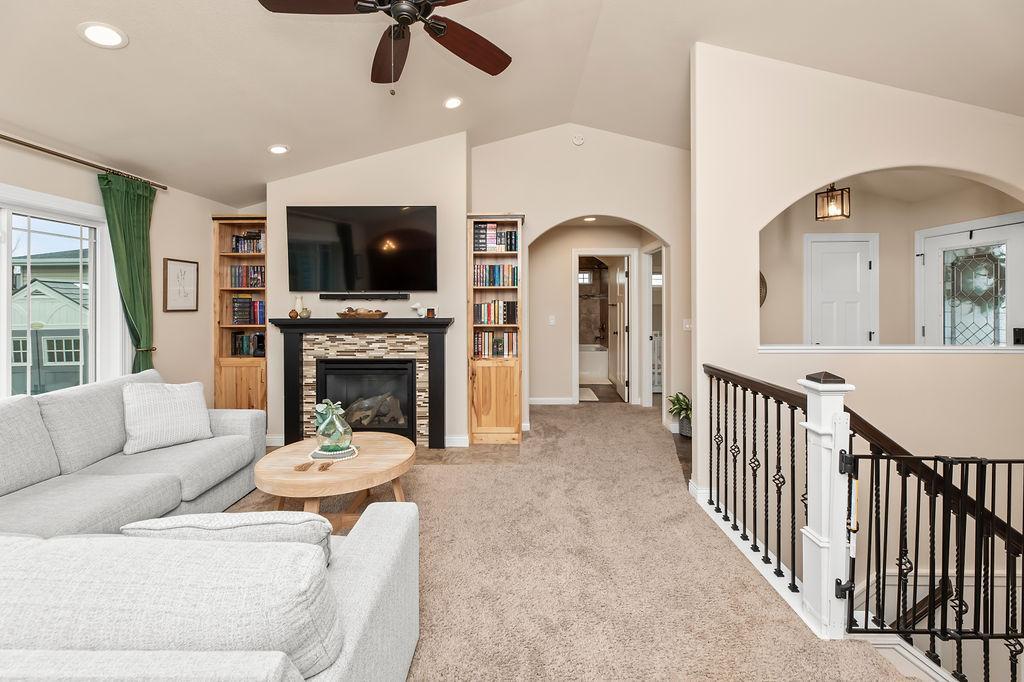 Cozy living room with gas fireplace. Charming arched openings throughout the home.