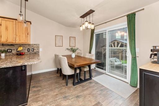 Dining area w/ patio door to a gorgeous backyard oasis