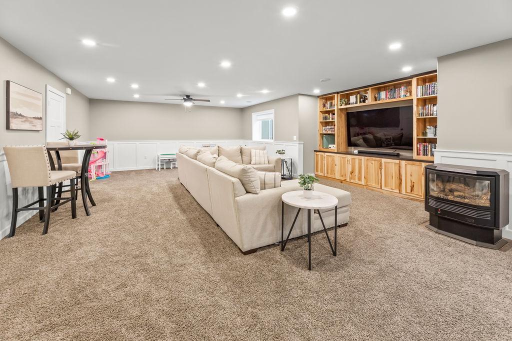 Recessed lighting, hickory cabinet built-in entertainment center, ceiling fan