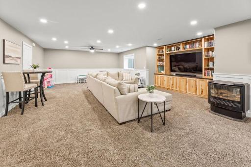 Recessed lighting, hickory cabinet built-in entertainment center, ceiling fan