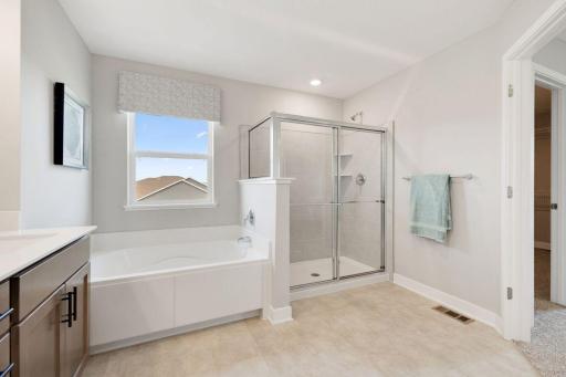 Double bowl vanity, separate tub and shower - with tiled shower surround - provide the primary bedroom with private ensuite oasis.