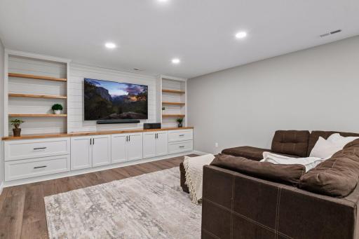 Lower level recreation area with recessed lighting open to adjoining family room