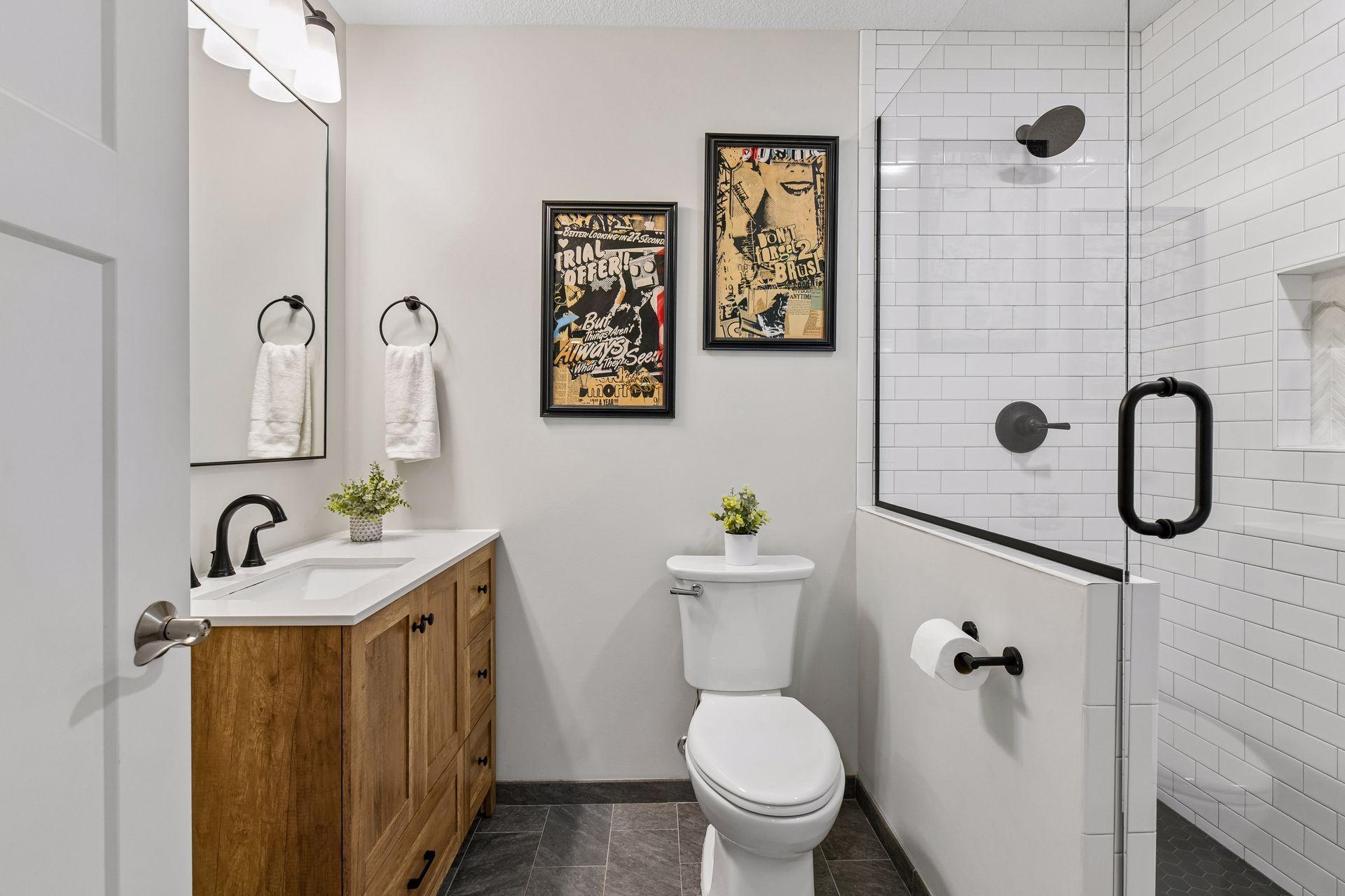 Three-quarter bath with vanity, walk-in shower, and tile surround