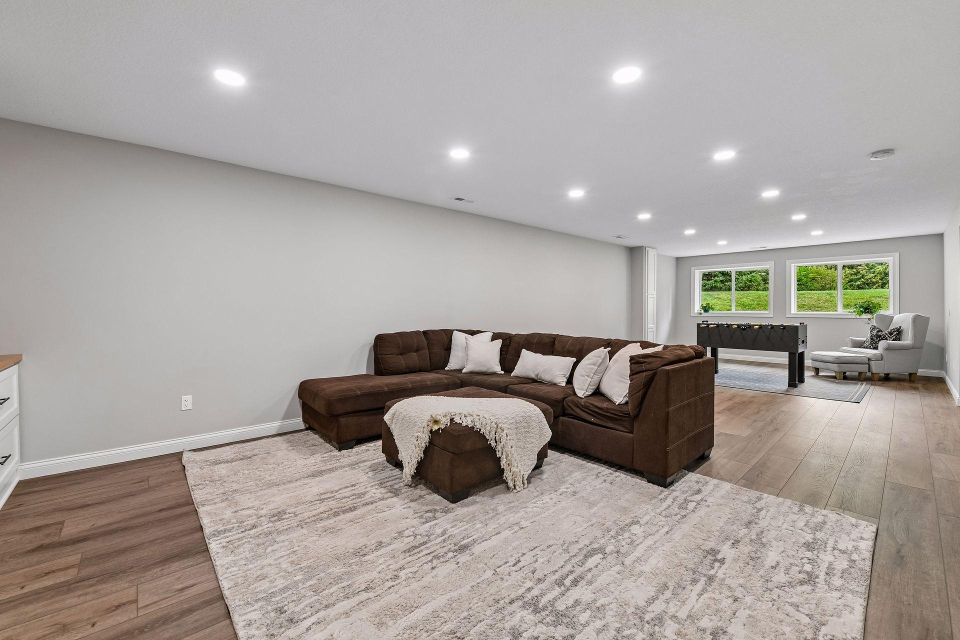 Lower level family room open to recreation area with recessed lighting and window