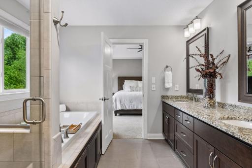 Primary bath with soaking tub, and large tiled shower surround
