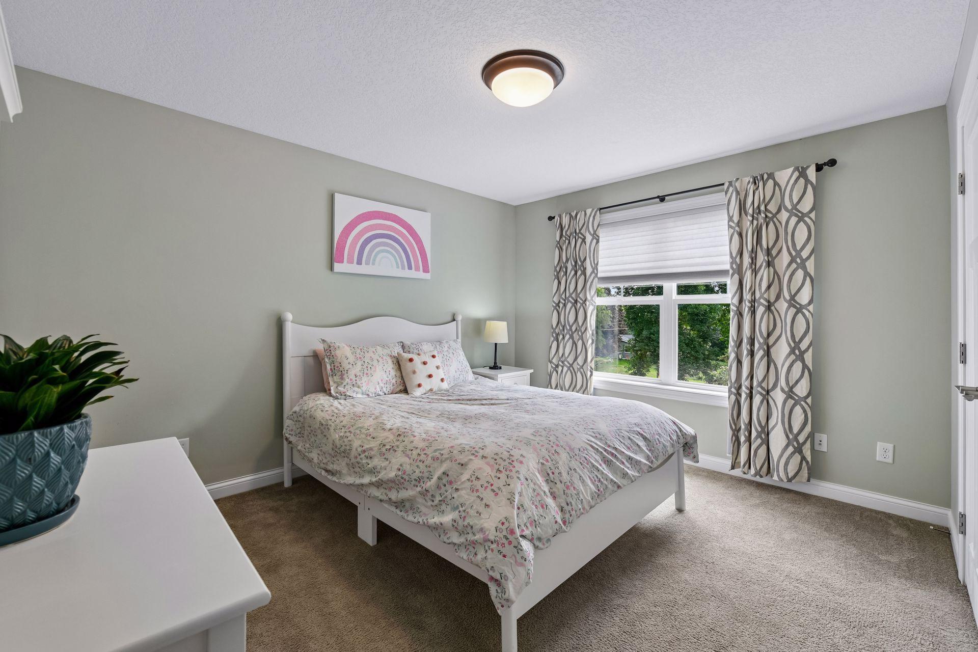 Upstairs bedroom with walk in closet overlooking backyard