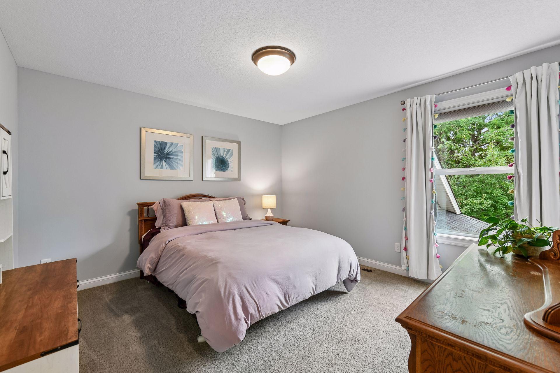Upstairs bedroom with walk in closet with views of the backyard