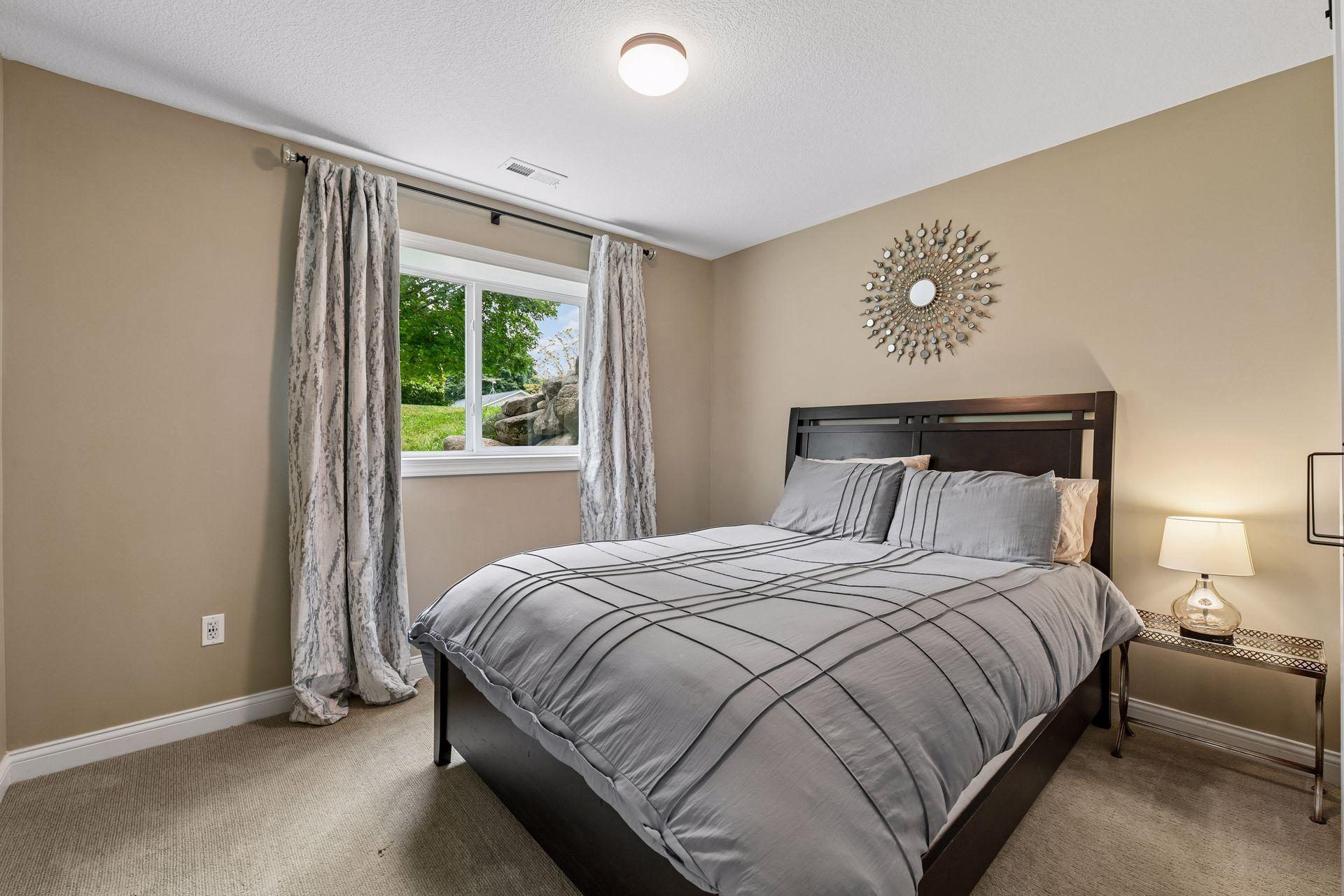 Lower level bedroom with closet looking out to side yard.