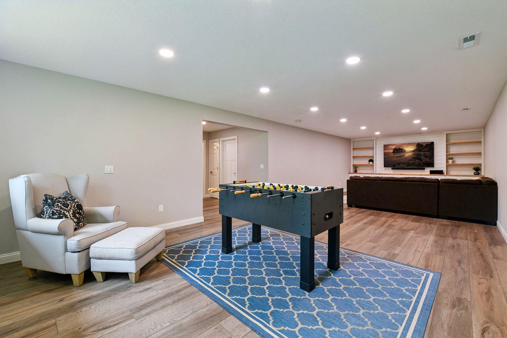 Lower level recreation area with recessed lighting open to adjoining family room