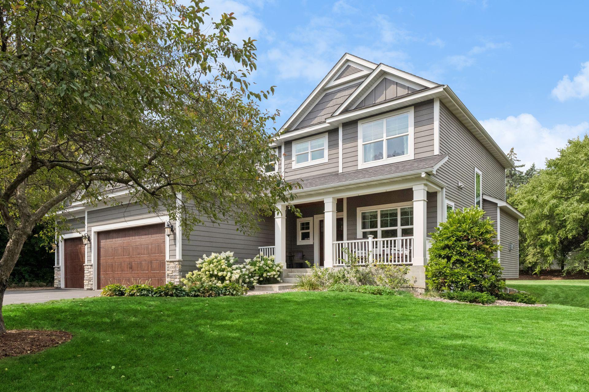 Front elevation showing gabled rooflines, covered front porch