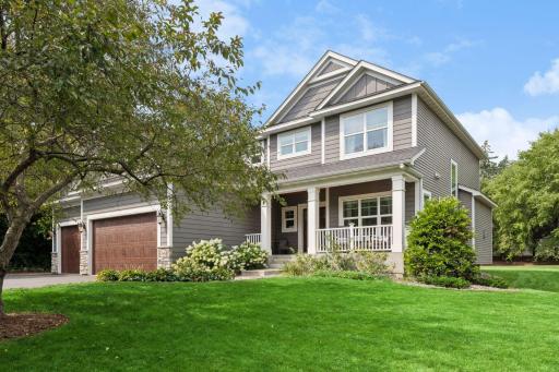 Front elevation showing gabled rooflines, covered front porch