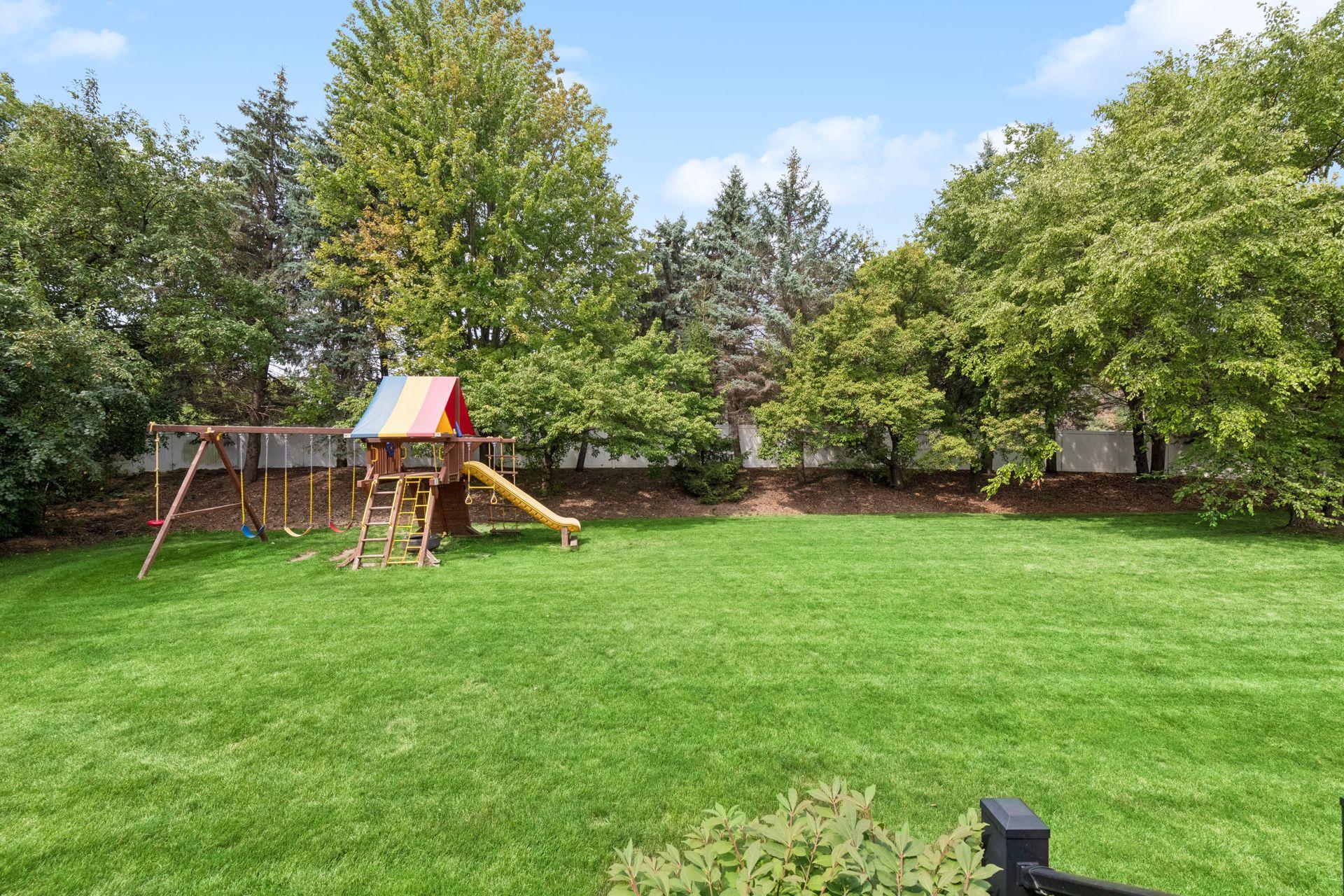 Private flat backyard with mature trees.
