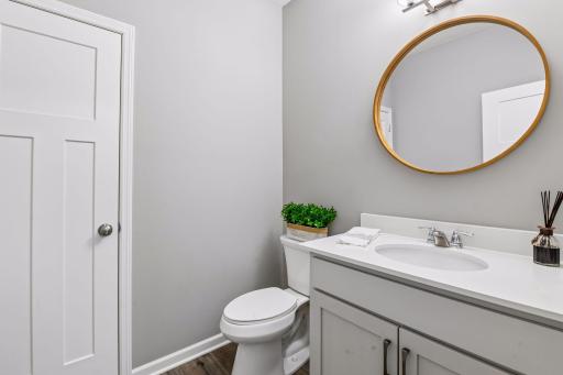 Main floor half bath off the front across from the office