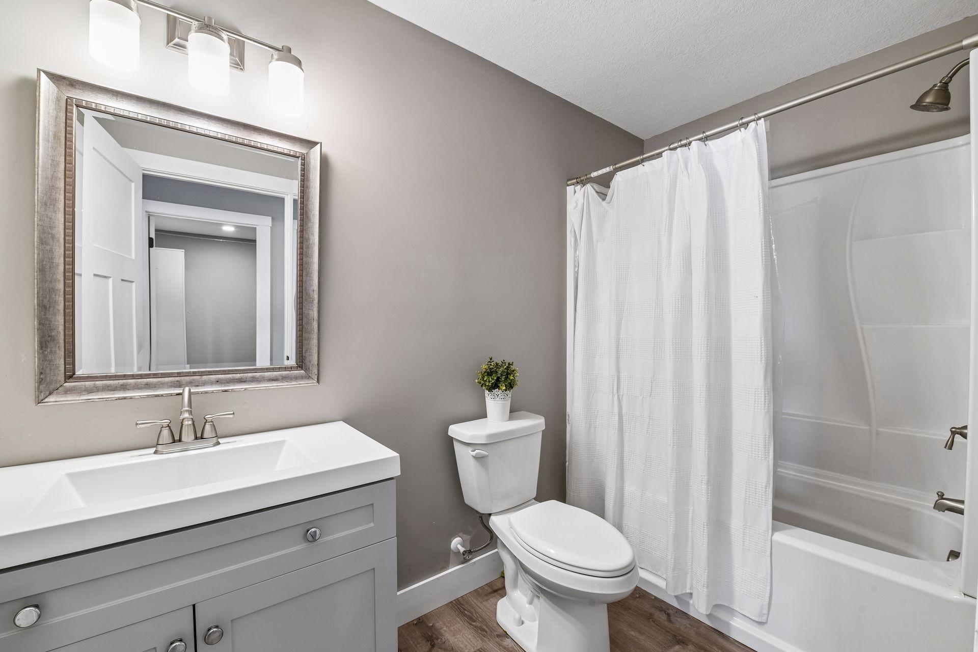Lower level bathroom complete with updated vanity and shower/tub combo