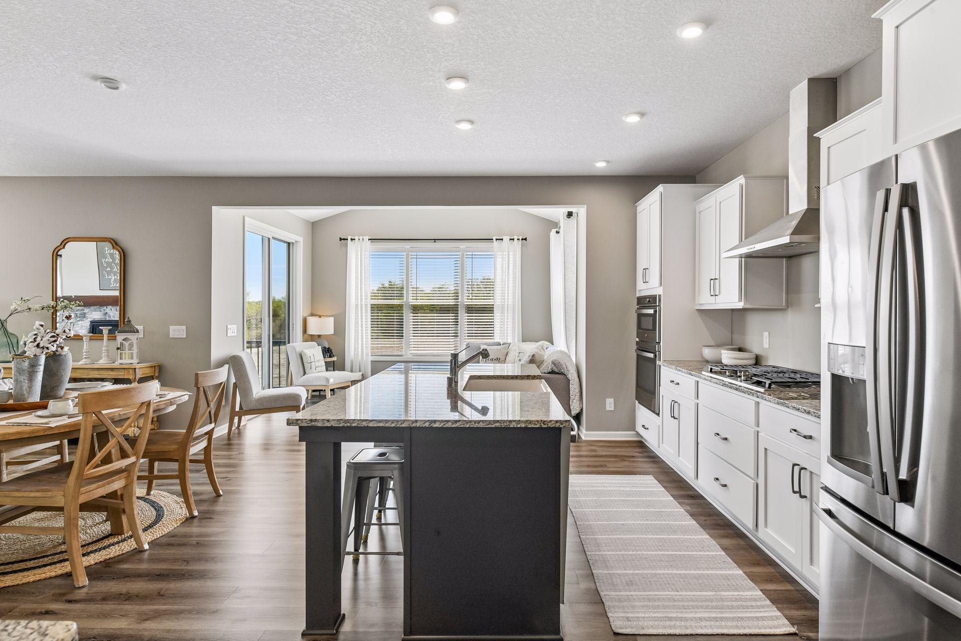 Just off the kitchen is sun room bump out with vaulted ceilings and access to maintenance free deck