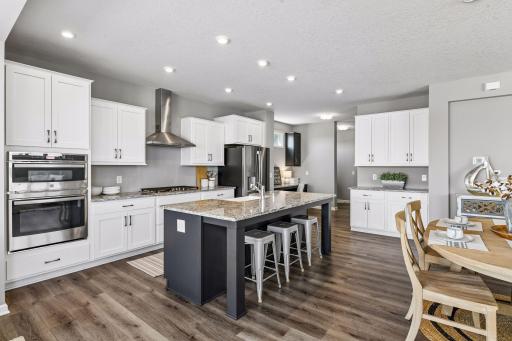 As you enter the home the kitchen is the heart of the main level. Granite countertops, gas range, oversized island and double oven makes this kitchen shine.