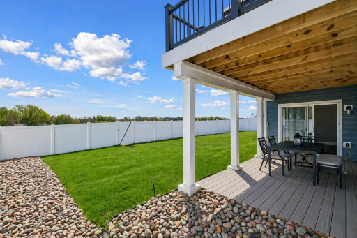 Covered 10x20 maintenance-free walkout deck off the basement, opening to a fully fenced yard with privacy vinyl fencing, and uninterrupted eastern views.
